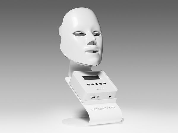 PRO by Déesse PRO LED mask resting on its display stand with control screen