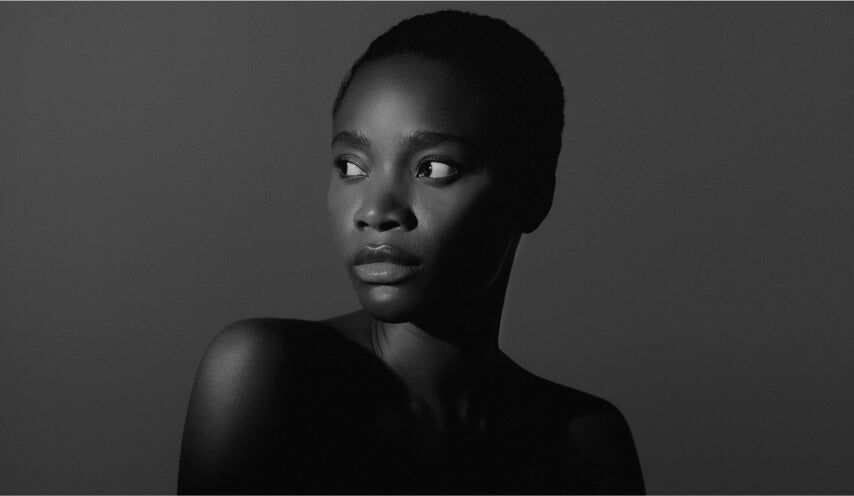 Black and white portrait of a woman looking to the side with bare shoulders