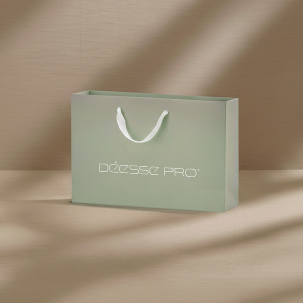 Large pale green matte gift bag with white handles and logo on front