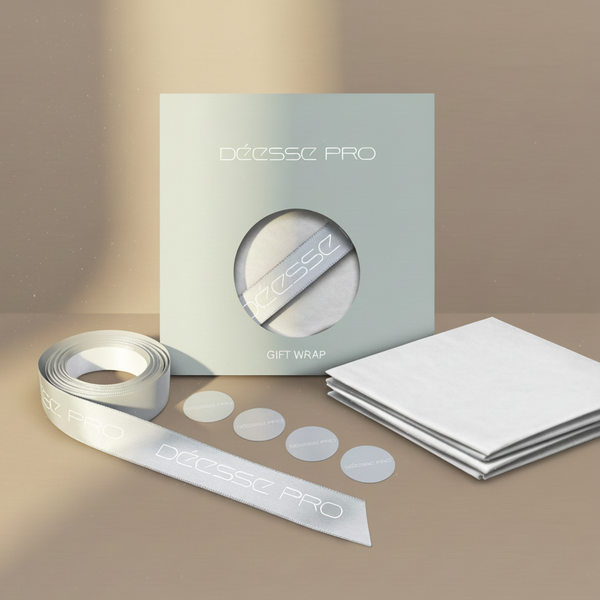 Festive gift wrap pack with white wrapping paper, branded ribbon, and matching circular stickers