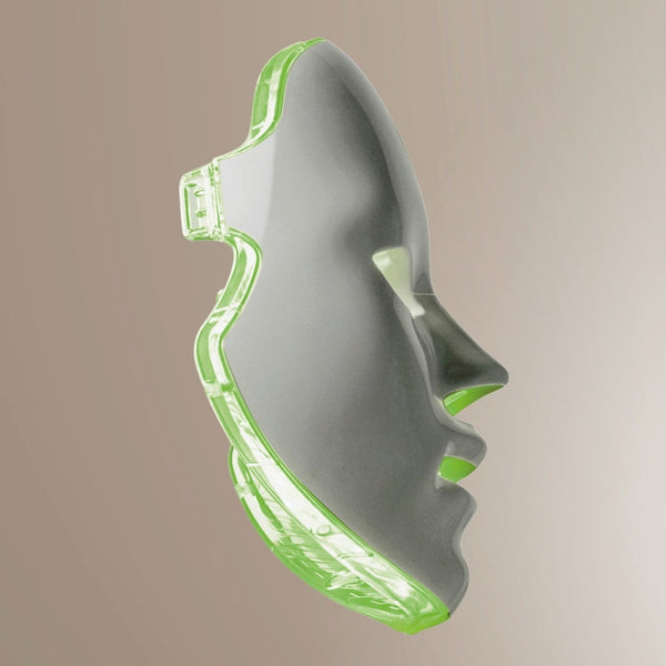 Transparent green and grey facial mask with contoured design for skincare treatments