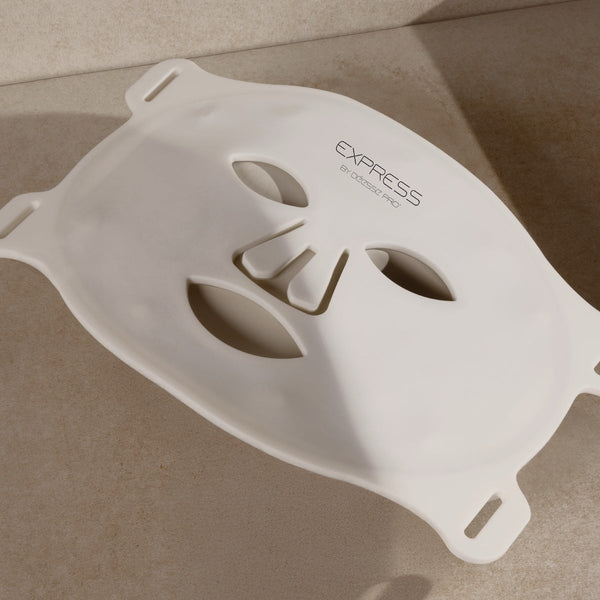 White flexible silicone facial mask with eye, nose, and mouth cutouts for skincare treatments